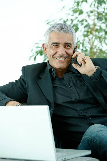 cypherMUSE Man Talking on an iPhone and using a MacBook Pro